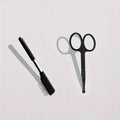Black pet grooming brush with soft silicone bristles and comb attachment for tear stain removal on dogs and cats