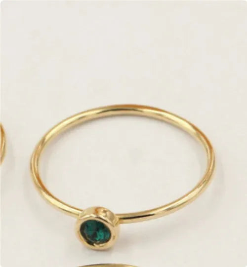 Women's 14K gilded GF zircon knuckle ring shown in green, blue, dark red, and white on a sizing chart.