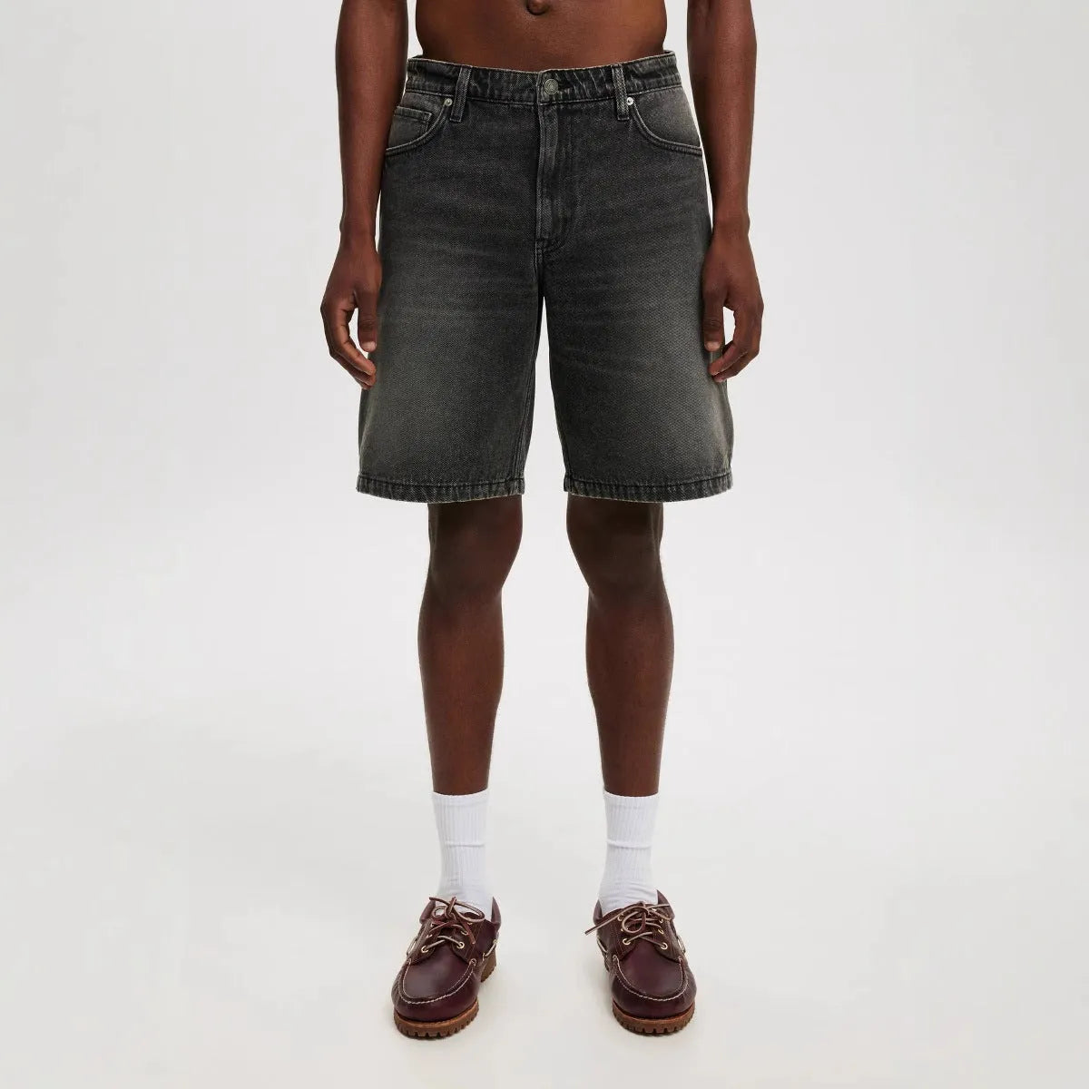 Men's loose straight-leg light blue cotton jeans on a white background.