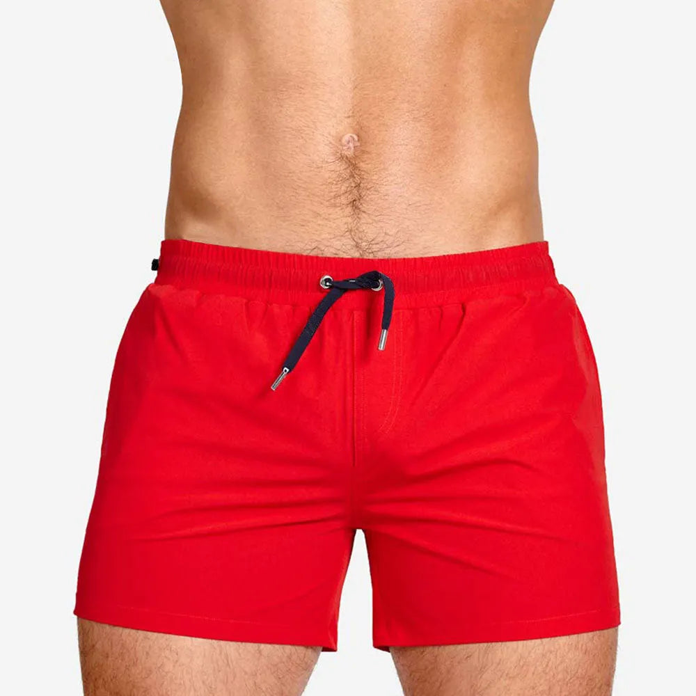 Men's solid colour polyester swimming shorts with mesh lining, shown in multiple colour options.