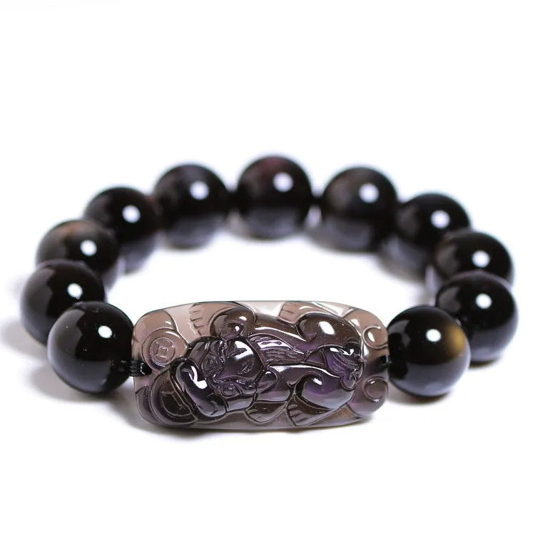 Polished natural crystal Pi Xiu bracelet with geometric beads on a wrist.