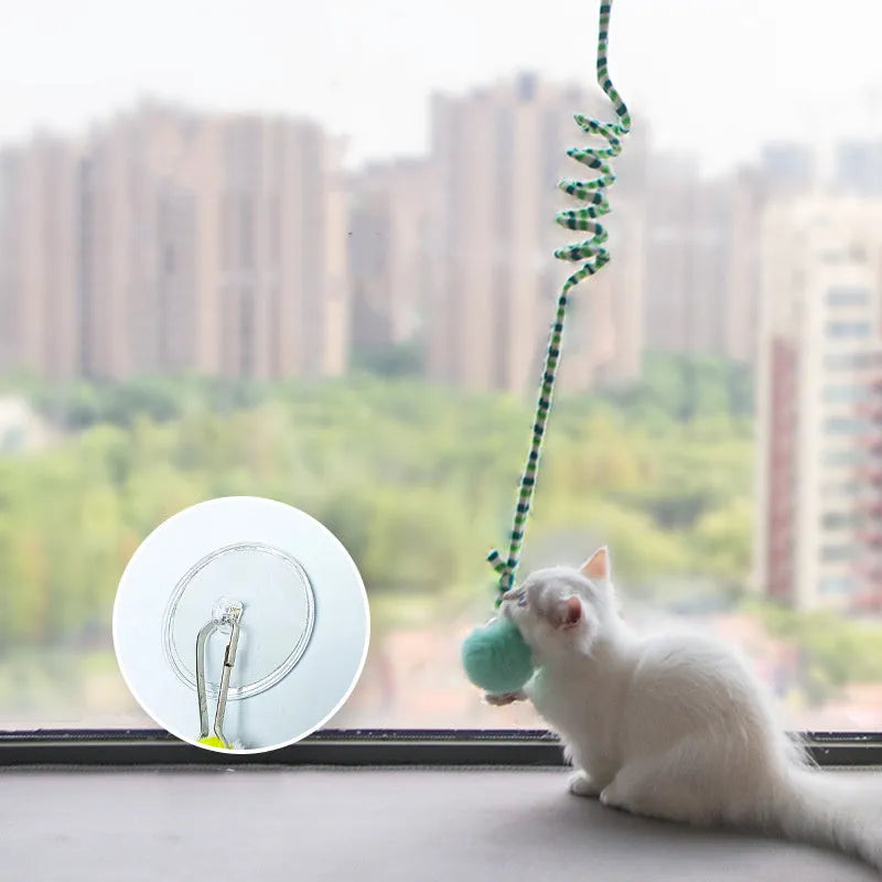 Cat toy with colourful inflatable bell ball on flexible wand and suction cup for door mounting