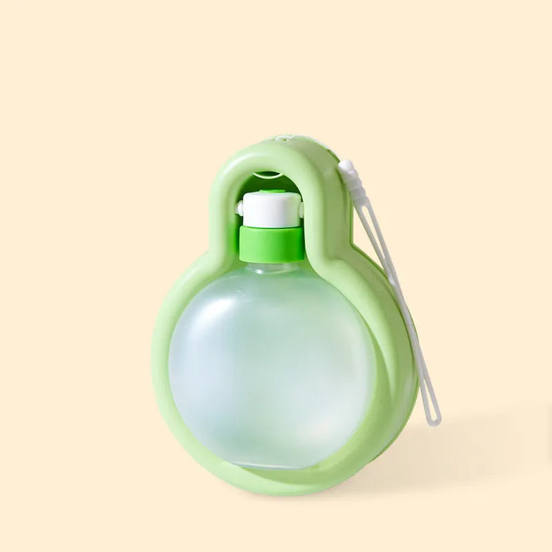 Green portable dog water bottle with integrated drinking bowl for outdoor travel and activities