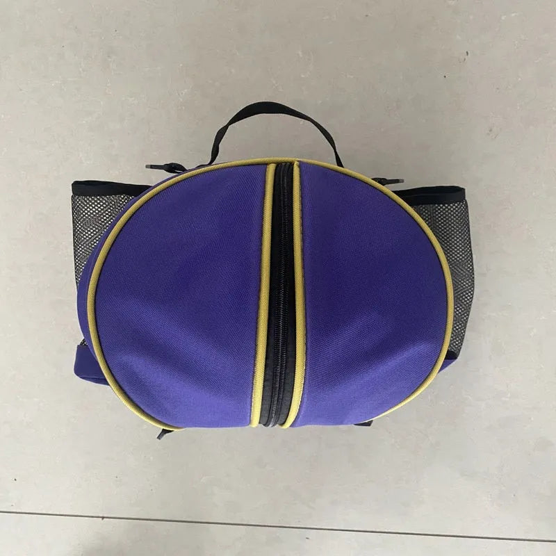 Black Oxford cloth basketball training bag with a single shoulder strap, shown next to a basketball.