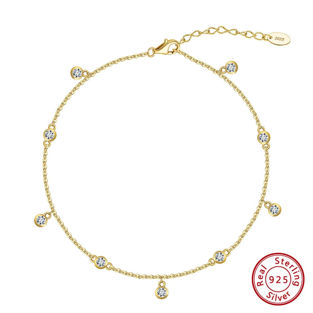 Women's silver anklet with small geometric zirconium pendant in gold tone.