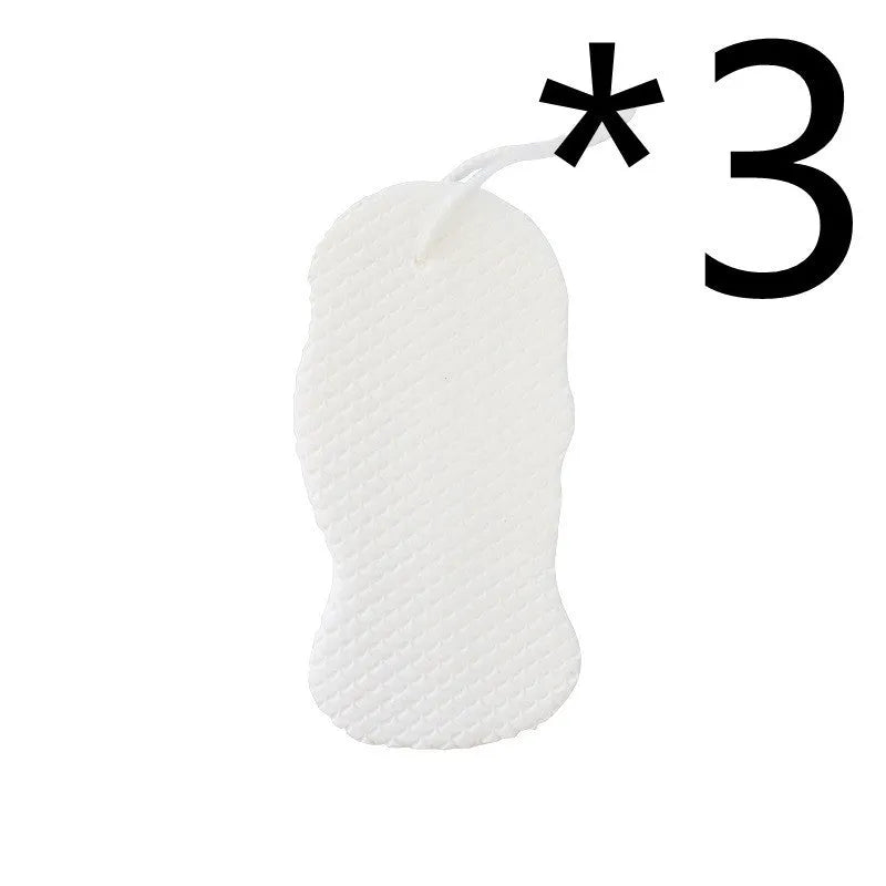 White 3D fish scale pattern bath sponge ball on a bathroom surface