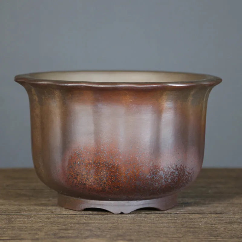 Large indoor ceramic flowerpot with antique carved flower design in purple sand clay