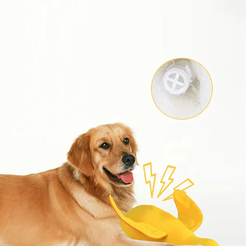Yellow plush duck dog toy with a sound module and treat-dispensing openings.