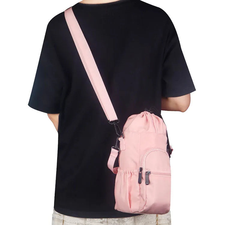 Canvas water bottle shoulder bag with crossbody strap in black, green, and pink colour options.