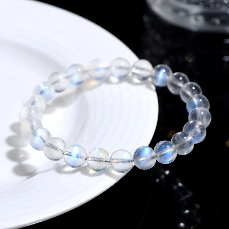 Natural cream body crystal bracelet with spherical beads on a wrist, showing minimalist unisex design.