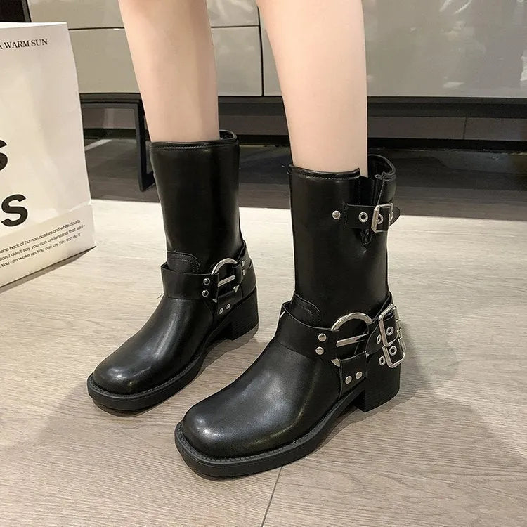 Black and brown women's platform boots with buckle details on the calf.