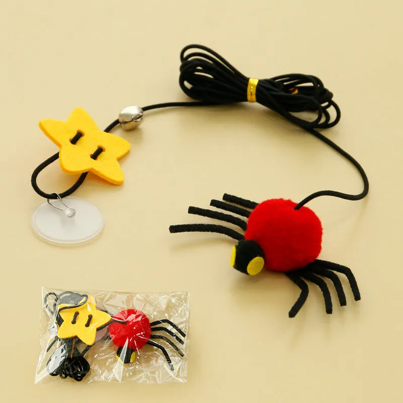 Hanging elastic rope cat toy with feather, bell and spider elements on playing stick in red colour