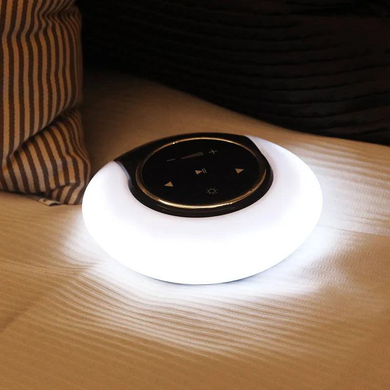Blue Bluetooth speaker LED desk lamp with touch controls and folding design on wooden desktop