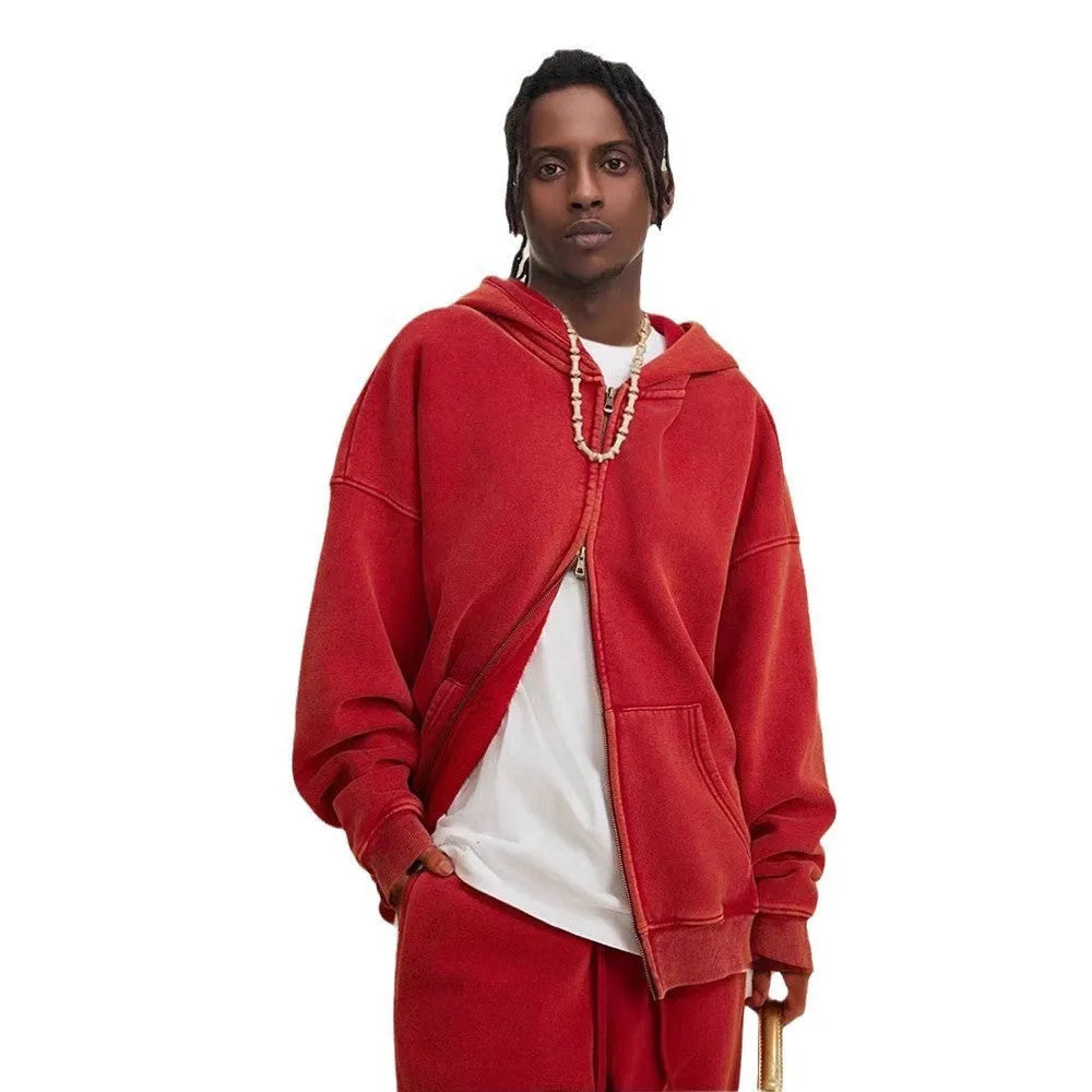 Man wearing a washed black fleece-lined cotton hooded cardigan with a double zipper.
