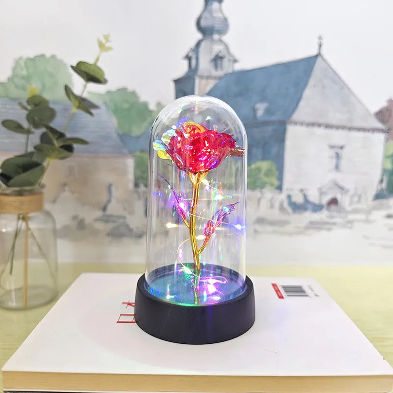 Small plastic night lamp with glass cover and flower decoration on black base