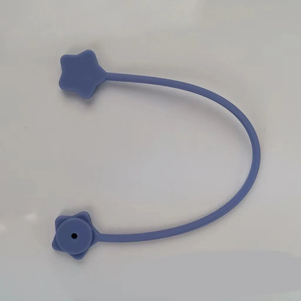 Purple silicone star-shaped magnet winder for clipping onto and organising headphone or phone charging cables.