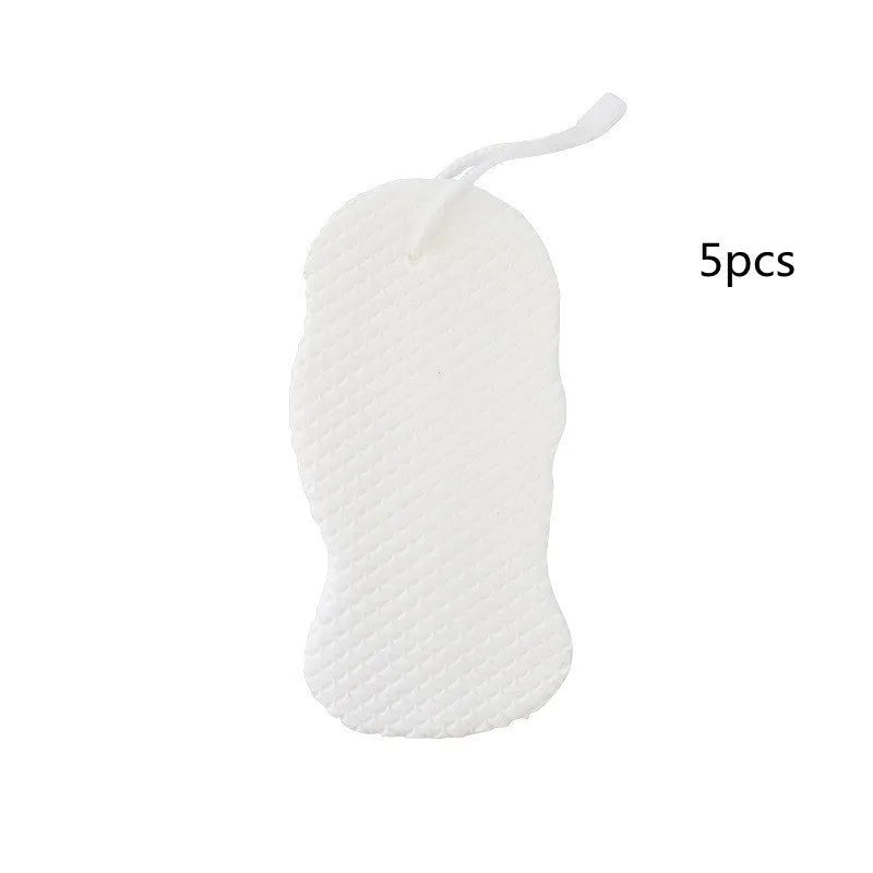 White 3D fish scale pattern bath sponge ball on a bathroom surface