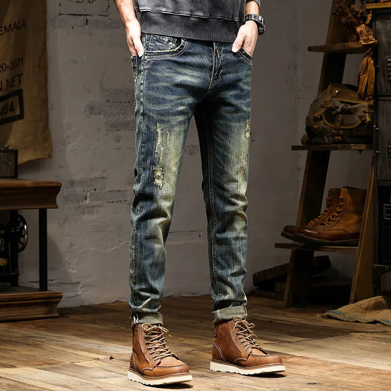 Men's skinny fit stretch denim jeans in a retro colour with a zip fly, laid flat.