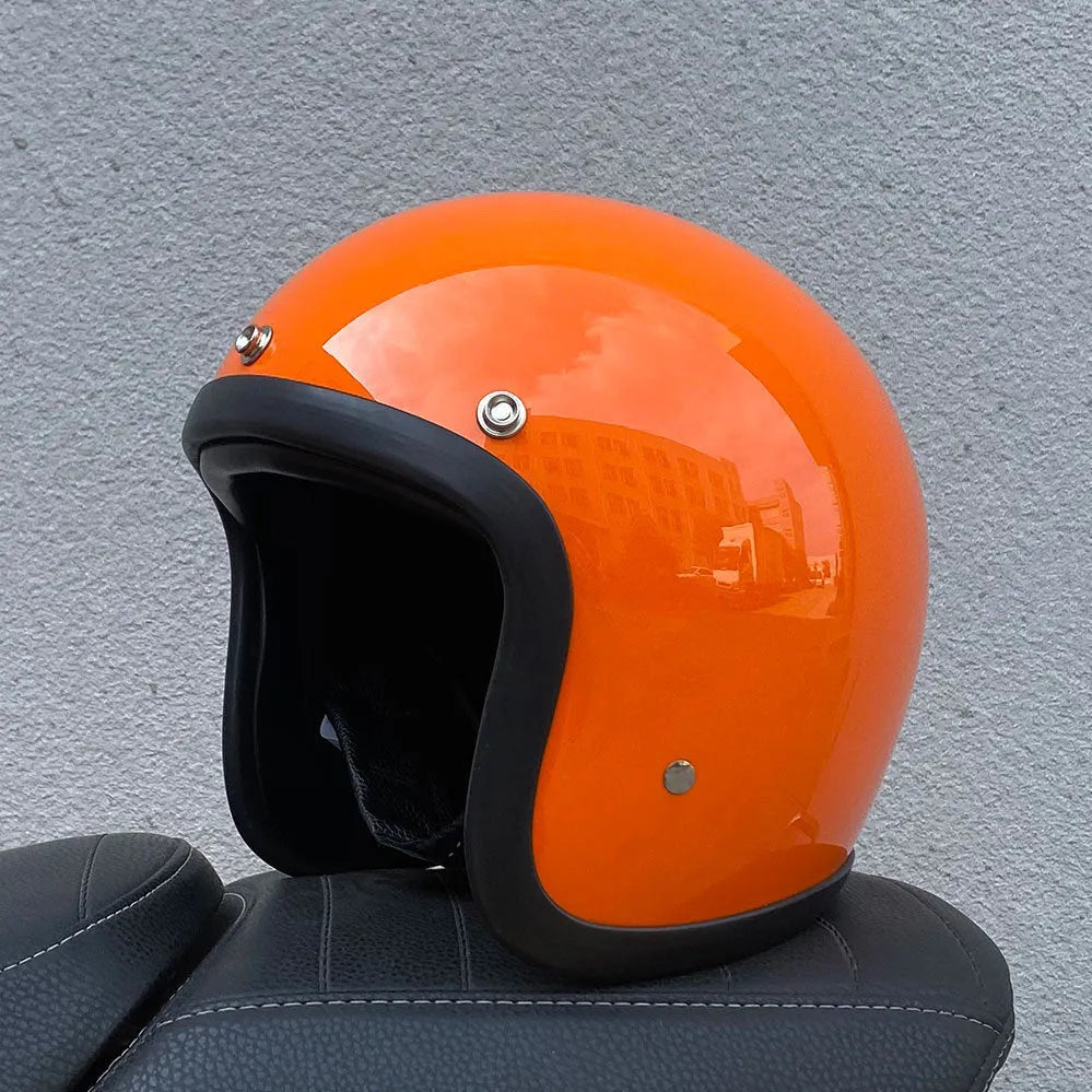 A cement grey retro-style motorcycle half helmet with a floral pattern on the side, showing its open-face design.
