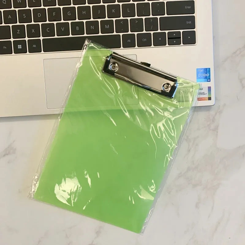 Transparent A4 writing board pad with metal clip holding paper, shown in blue colour variant.