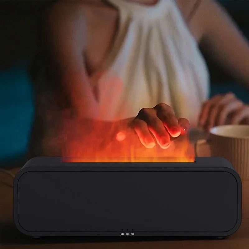 Black and white USB essential oil aroma diffuser with colour-changing light and remote control on a desk