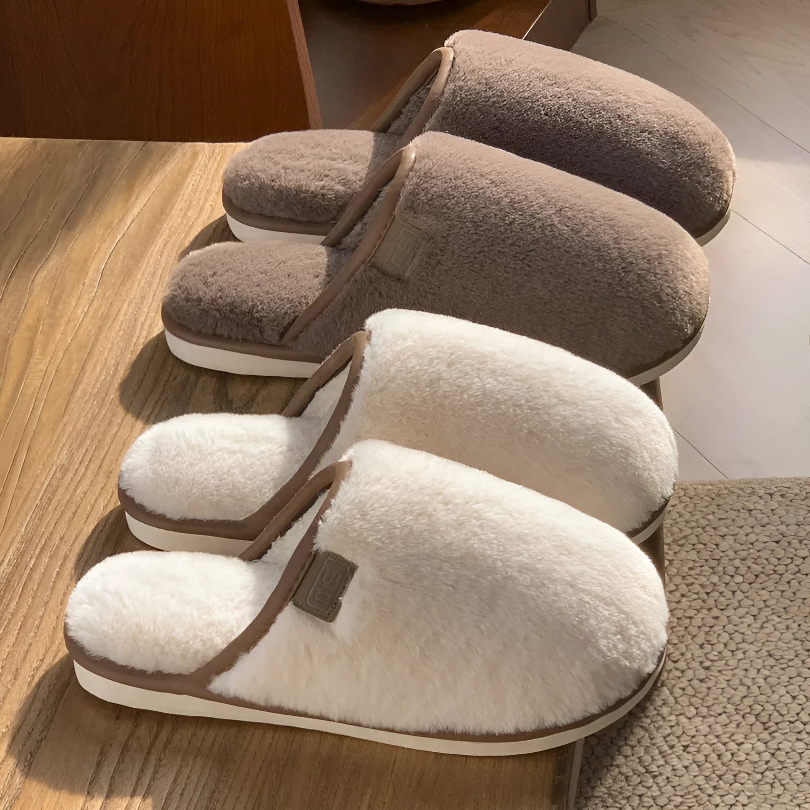 A pair of solid colour plush winter slippers with a non-slip PVC sole and car stitching detail.