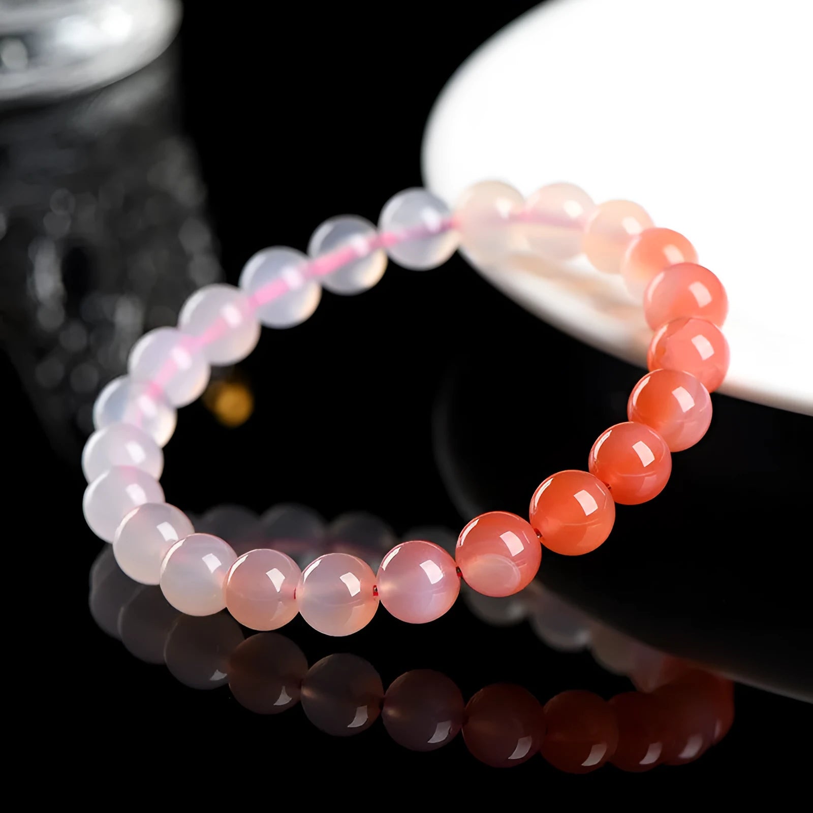 Natural gradient colour agate bracelet with geometric beads on a wrist.