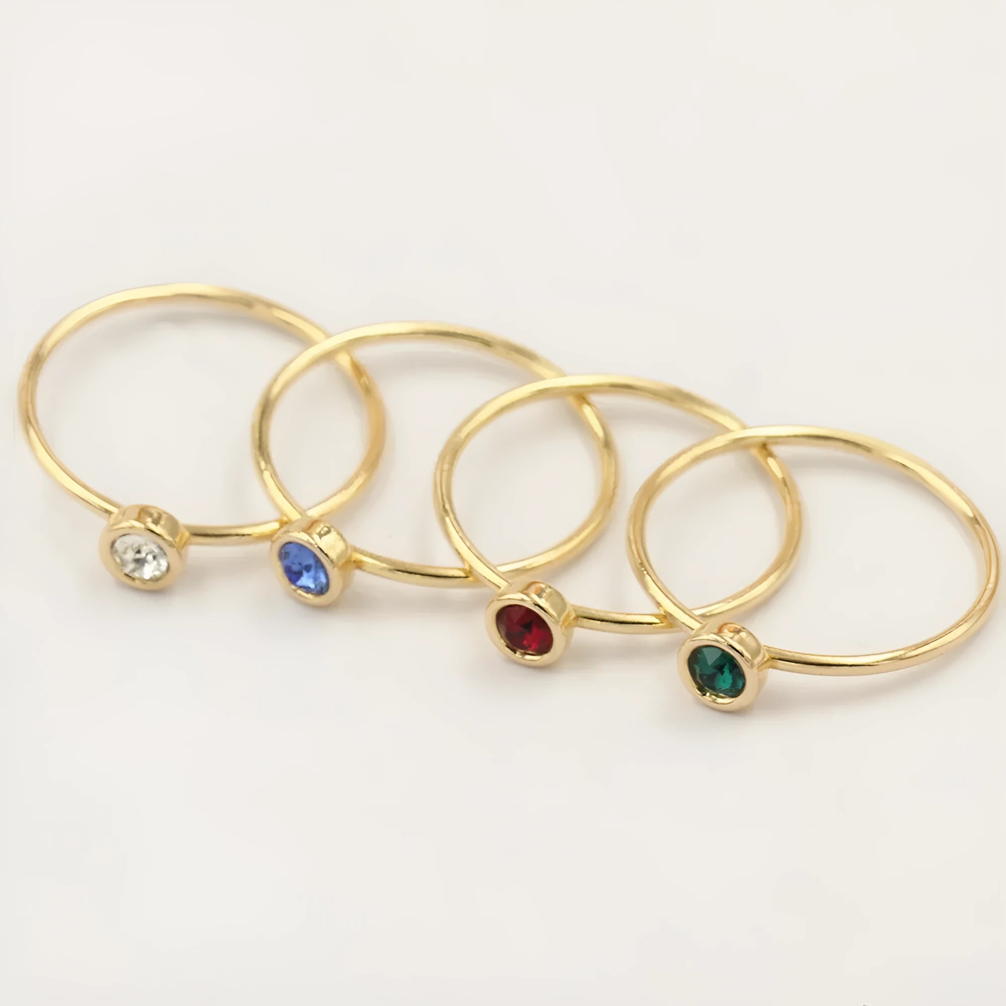 Women's 14K gilded GF zircon knuckle ring shown in green, blue, dark red, and white on a sizing chart.