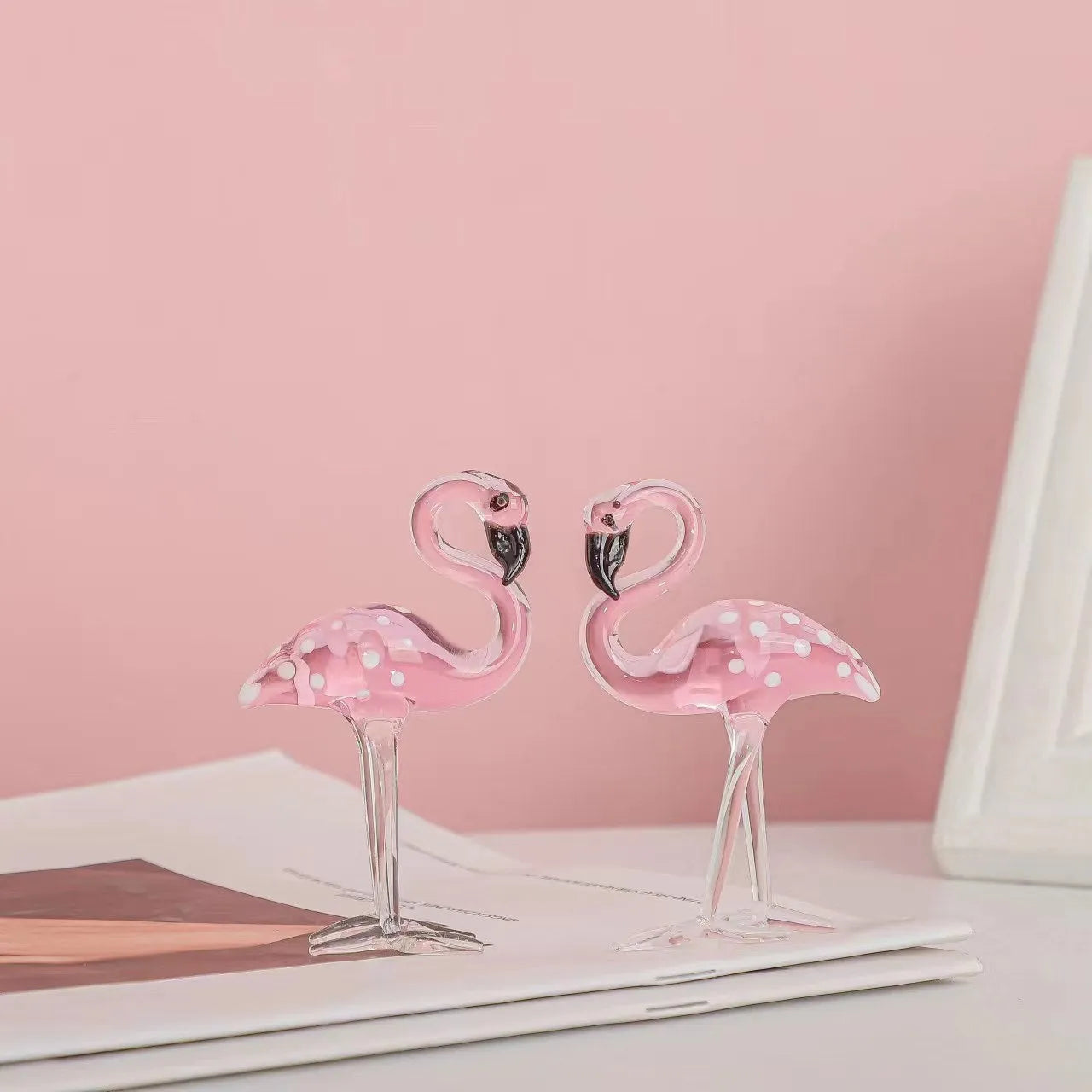 Pink crystal flamingo decorative sculpture on table with modern minimalist design