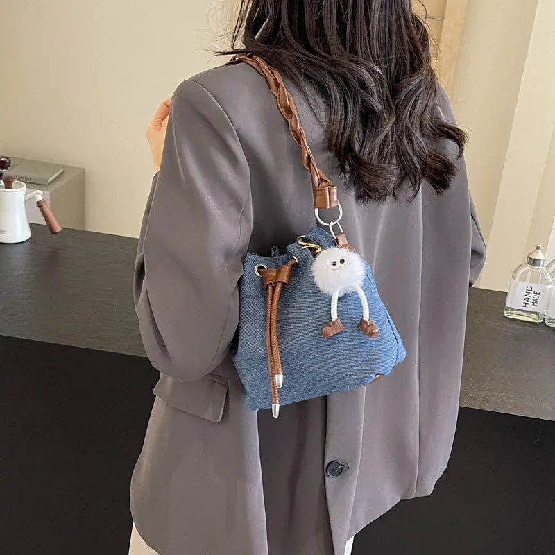 Blue synthetic leather cross body bucket bag with adjustable strap and sandwich pocket
