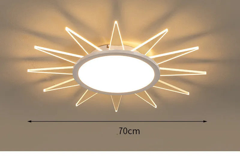 Modern round aluminium LED ceiling lamp with a white shade on a ceiling.