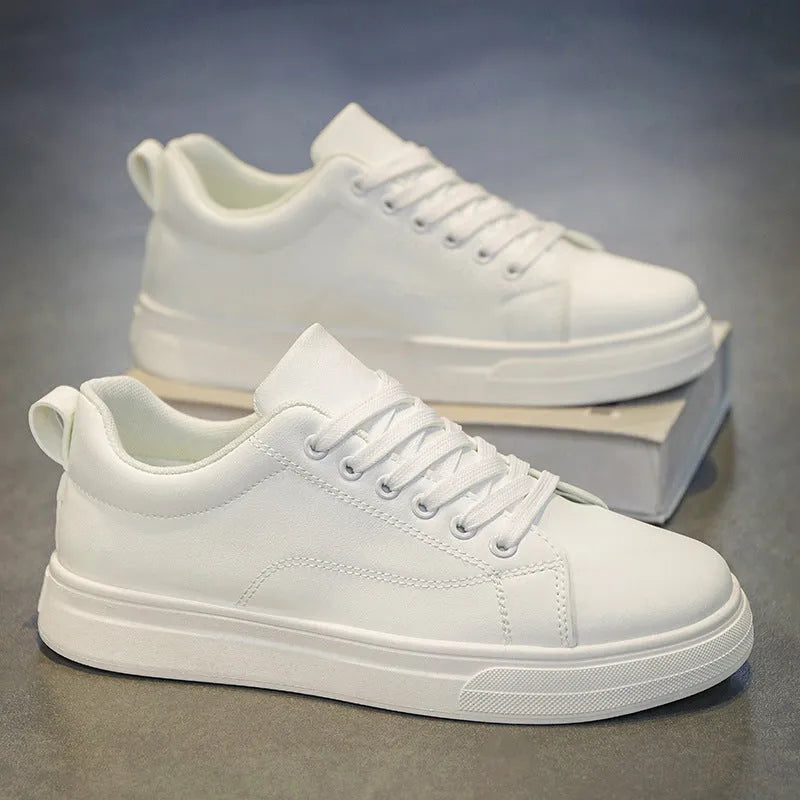 Men's low-top white breathable sneakers with a rubber sole on a plain background