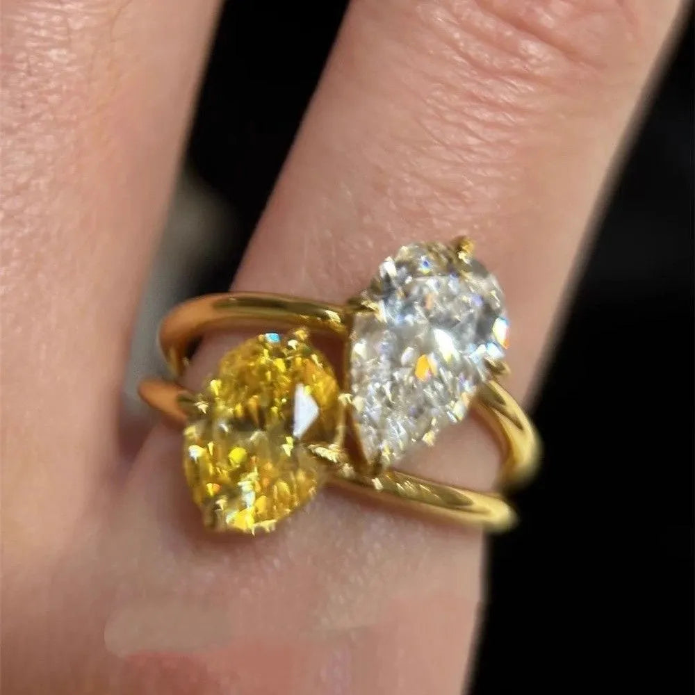 Geometric open copper ring for women with a central water drop double Sheng zircon stone.