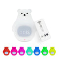 White cartoon bear silicone night light with remote control on table.