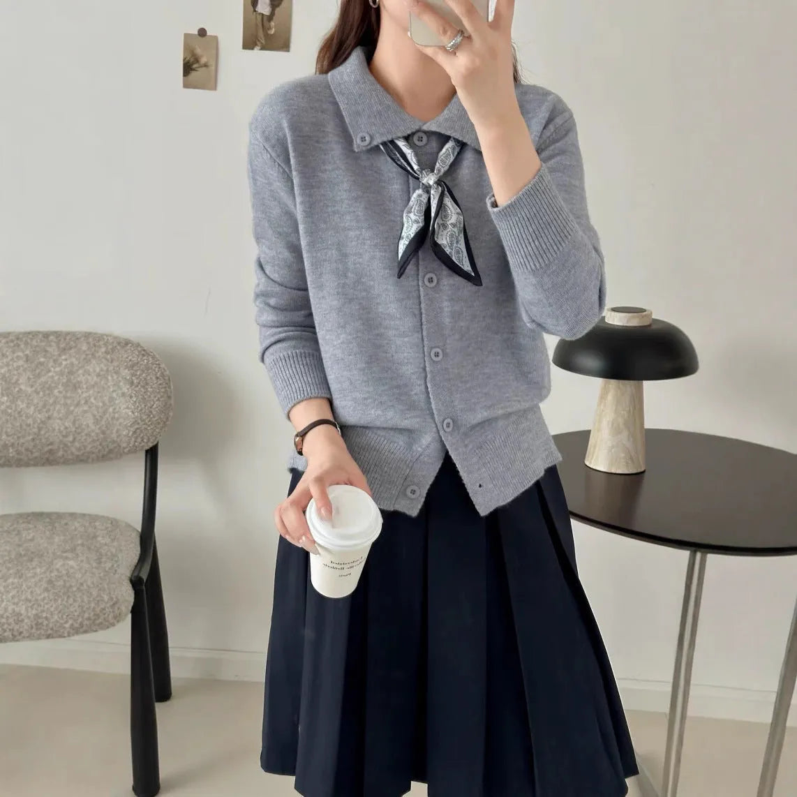 Beige lapel scarf collar acrylic cardigan with long sleeves on a hanger