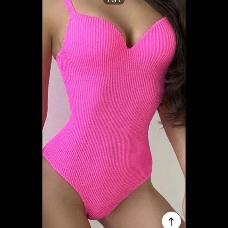 Women's black and striped one-piece sleeveless swimsuit laid flat.