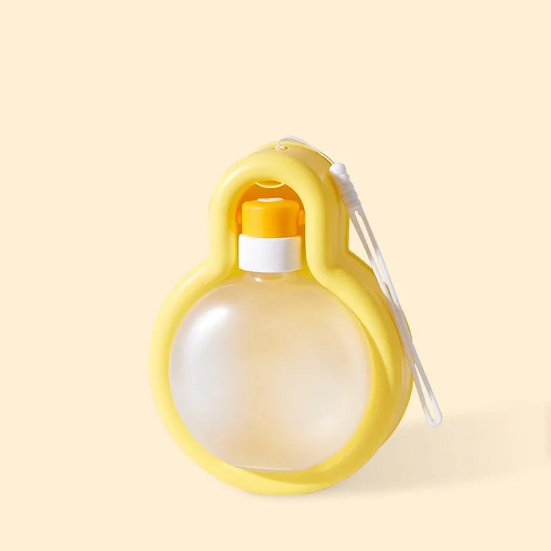 Green portable dog water bottle with integrated drinking bowl for outdoor travel and activities