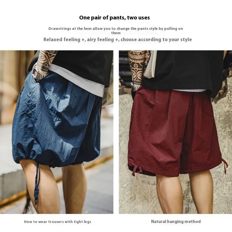 Men's loose fit Prussian Blue nylon beach shorts with embroidery on a summer background.
