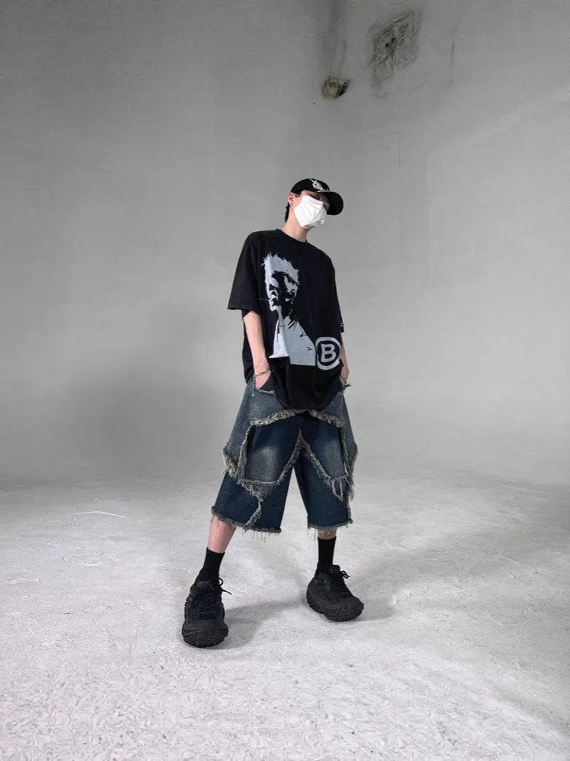 Blue men's denim shorts with a frayed hem and a large five-pointed star design on the leg.