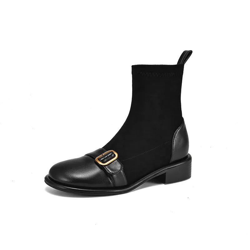 Women's black low-heel Martin boots with belt buckle detail and front lace-up fastening.