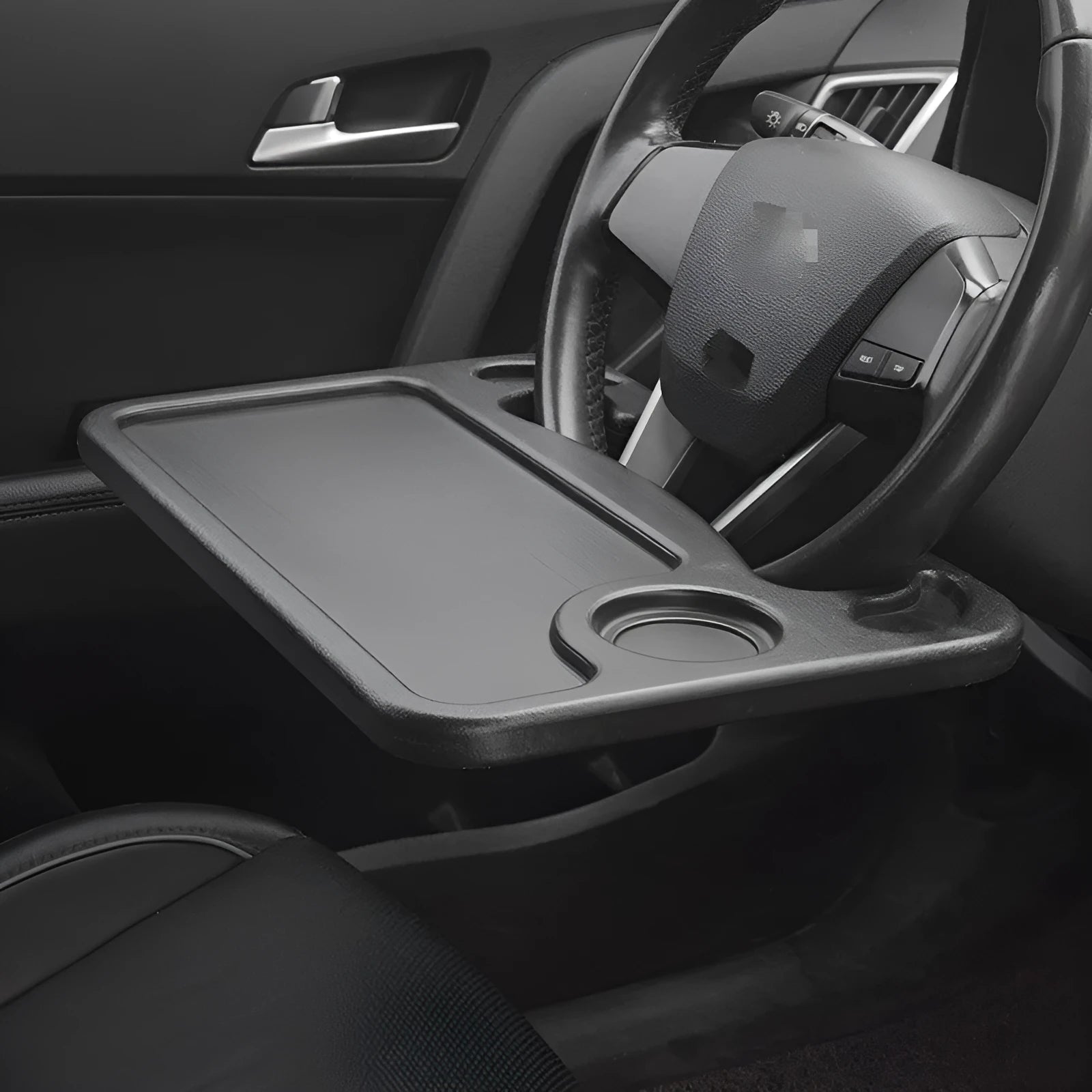 Black plastic car tray desk measuring 42cm by 28cm on a car seat