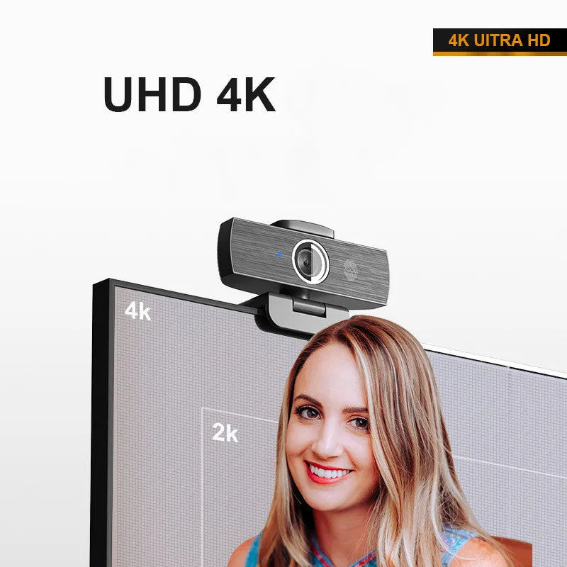 Black USB webcam with attached cable and a magnetic privacy cover on a desk.