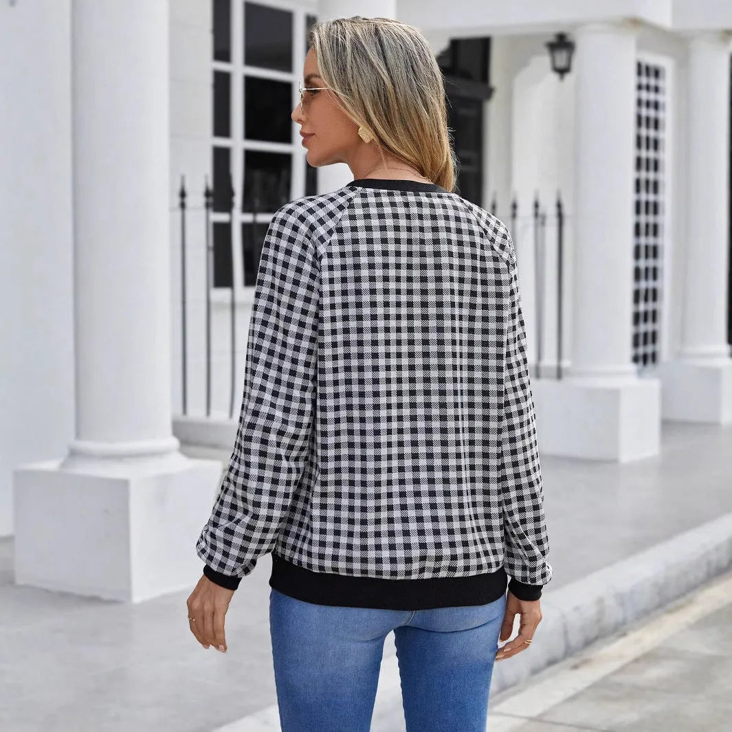 Black plaid and stripe pattern pullover sweater with long sleeves on mannequin