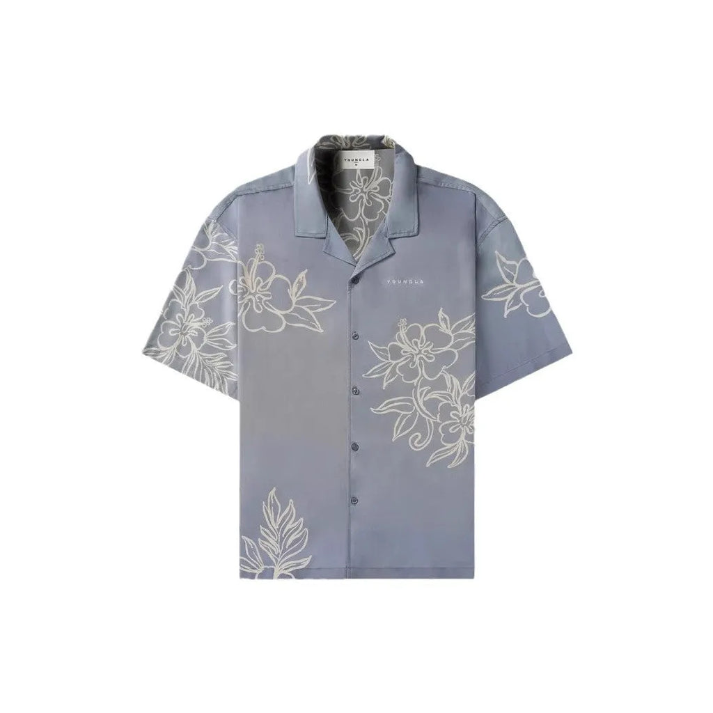 A man's loose-fitting, short-sleeve casual top with a floral print, shown in a light colour.