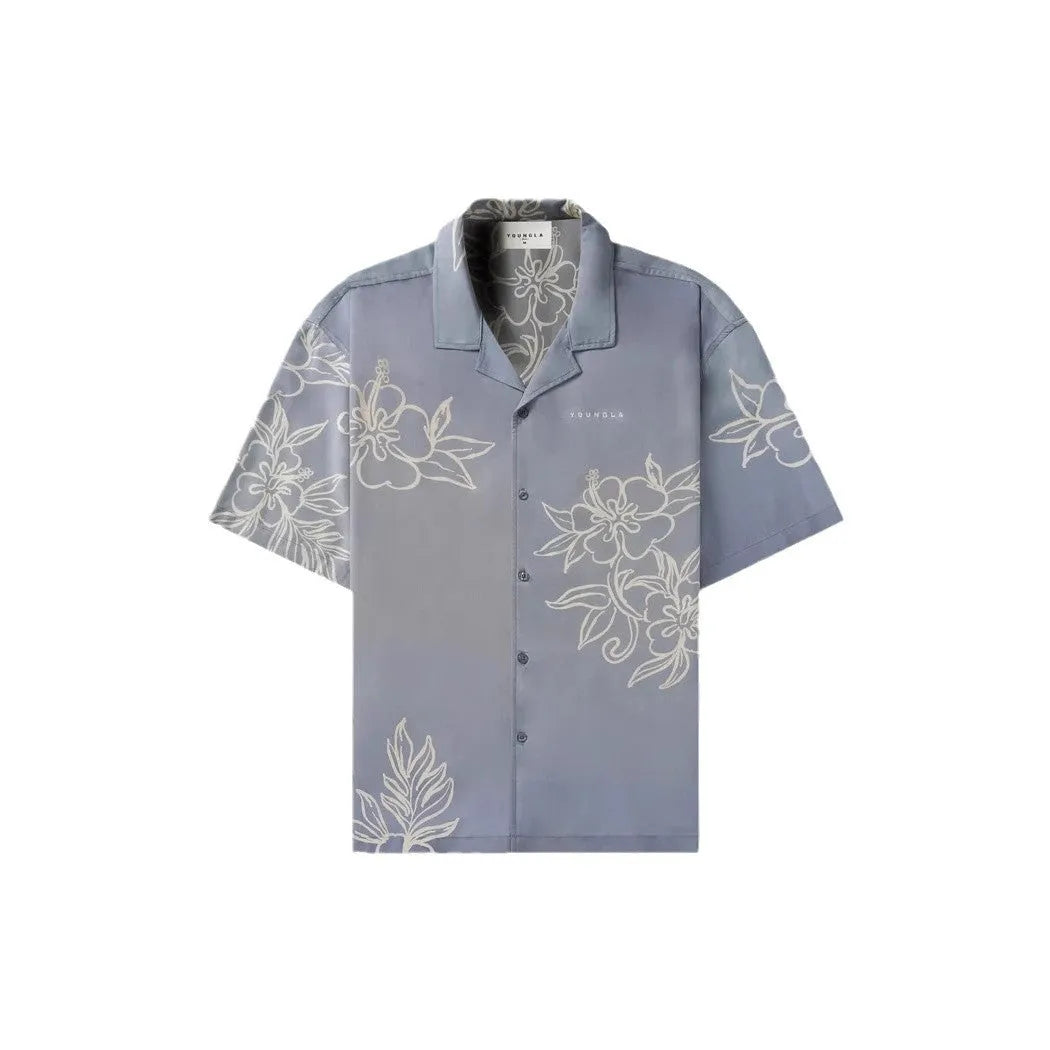 A man's loose-fitting, short-sleeve casual top with a floral print, shown in a light colour.