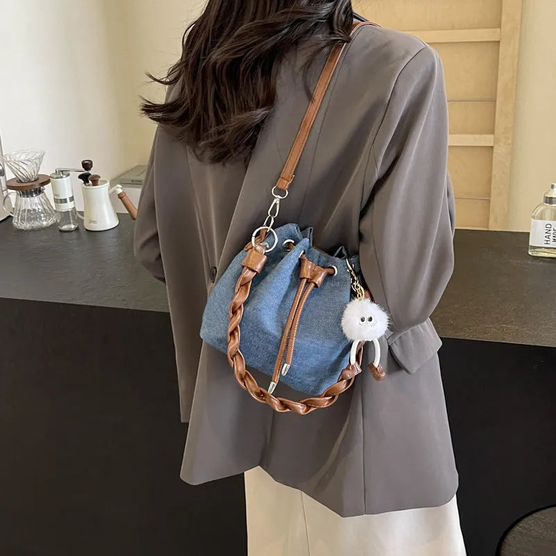 Blue synthetic leather cross body bucket bag with adjustable strap and sandwich pocket