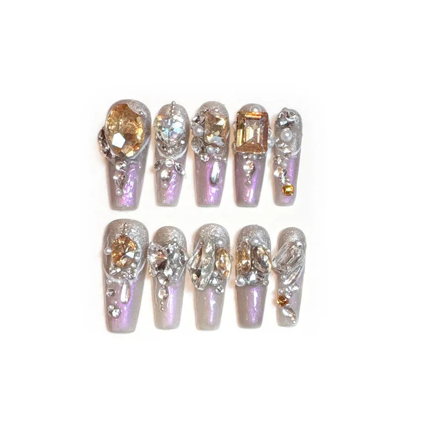 False nail patches with rhinestone decoration on card paper packaging with application tools