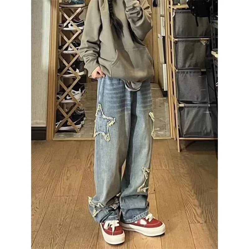 Blue high-waisted wide-leg denim trousers on a hanger, showing the straight-leg cut and front view.