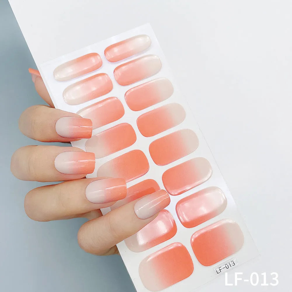 Set of 16 solid colour nail art stickers showing floral, geometric, and pattern designs for manicure application