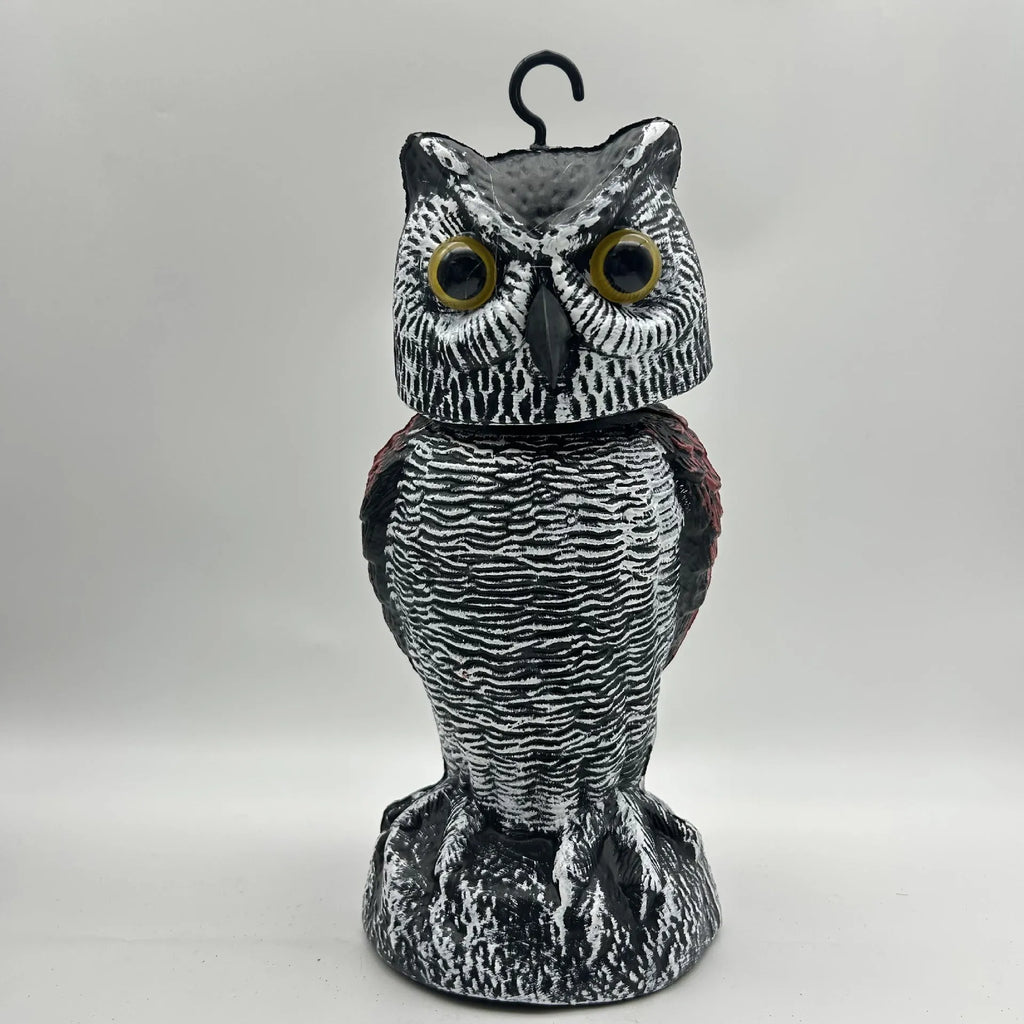 Artificial owl bait ornament with shaking head for garden bird deterrent in outdoor setting